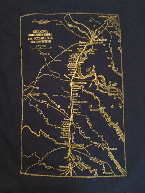 Detail photo of back of navy T-shirt showing map of the RF&P railroad in gold printing.
