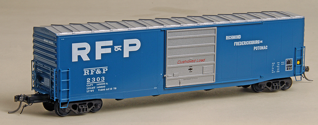 Photo of HO scale model boxcar in blue with silver door and roof lettered for RF&P on an off-white background.
